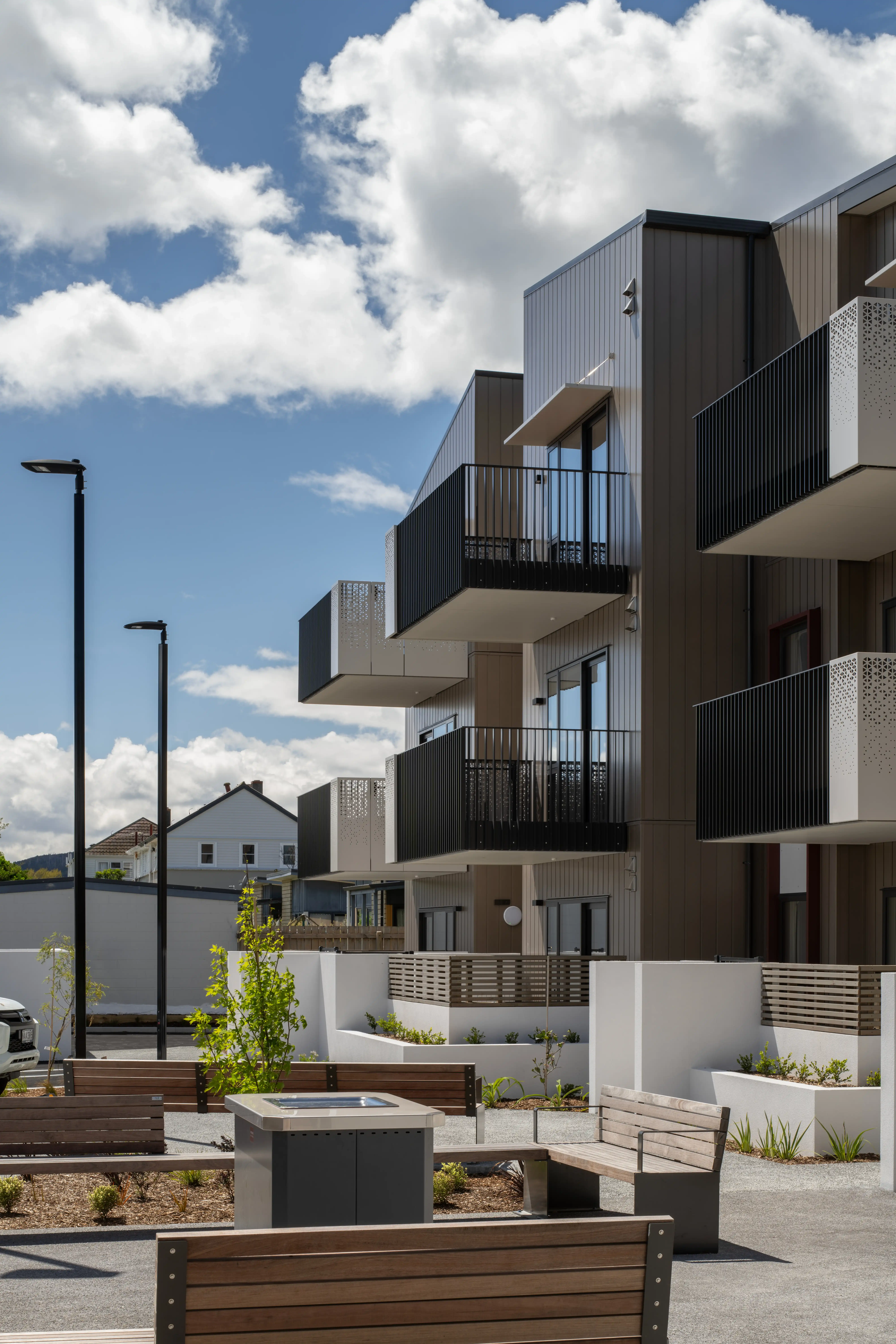 Prefabricated Grappler glide-on balcony at Oxford Terrace, seen from below where it meets the apartment facade.
