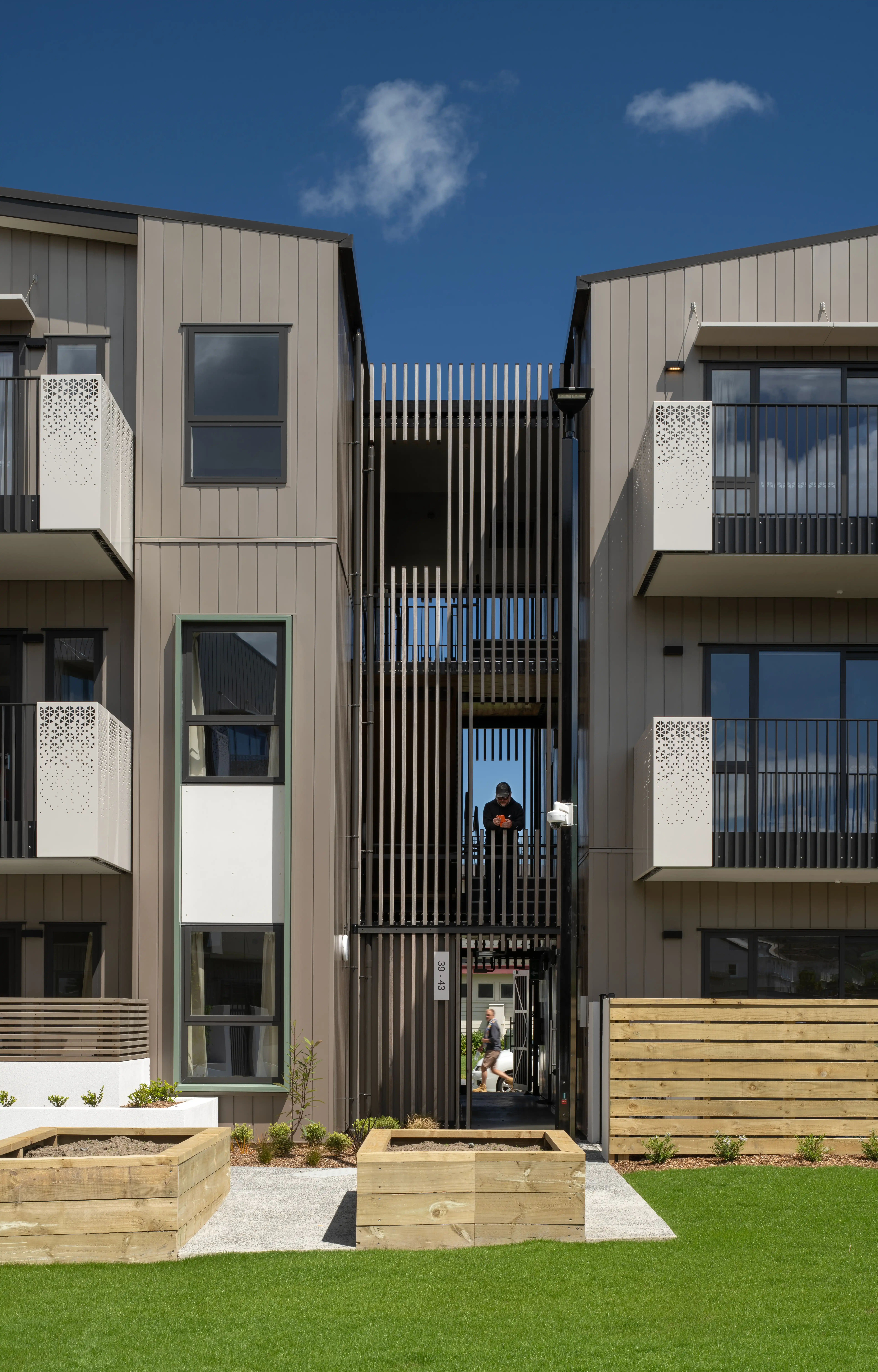View from an Oxford Terrace balcony down to the central garden where residents sit, garden and gather.