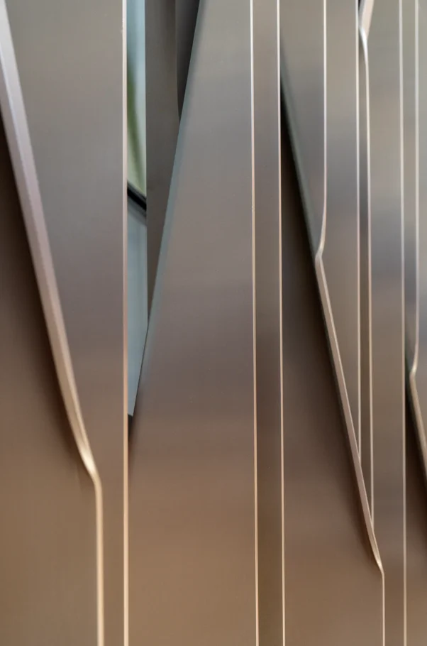 Close-up of twisting 200 × 10 mm aluminium fins in the High Commission of India's tracery screen