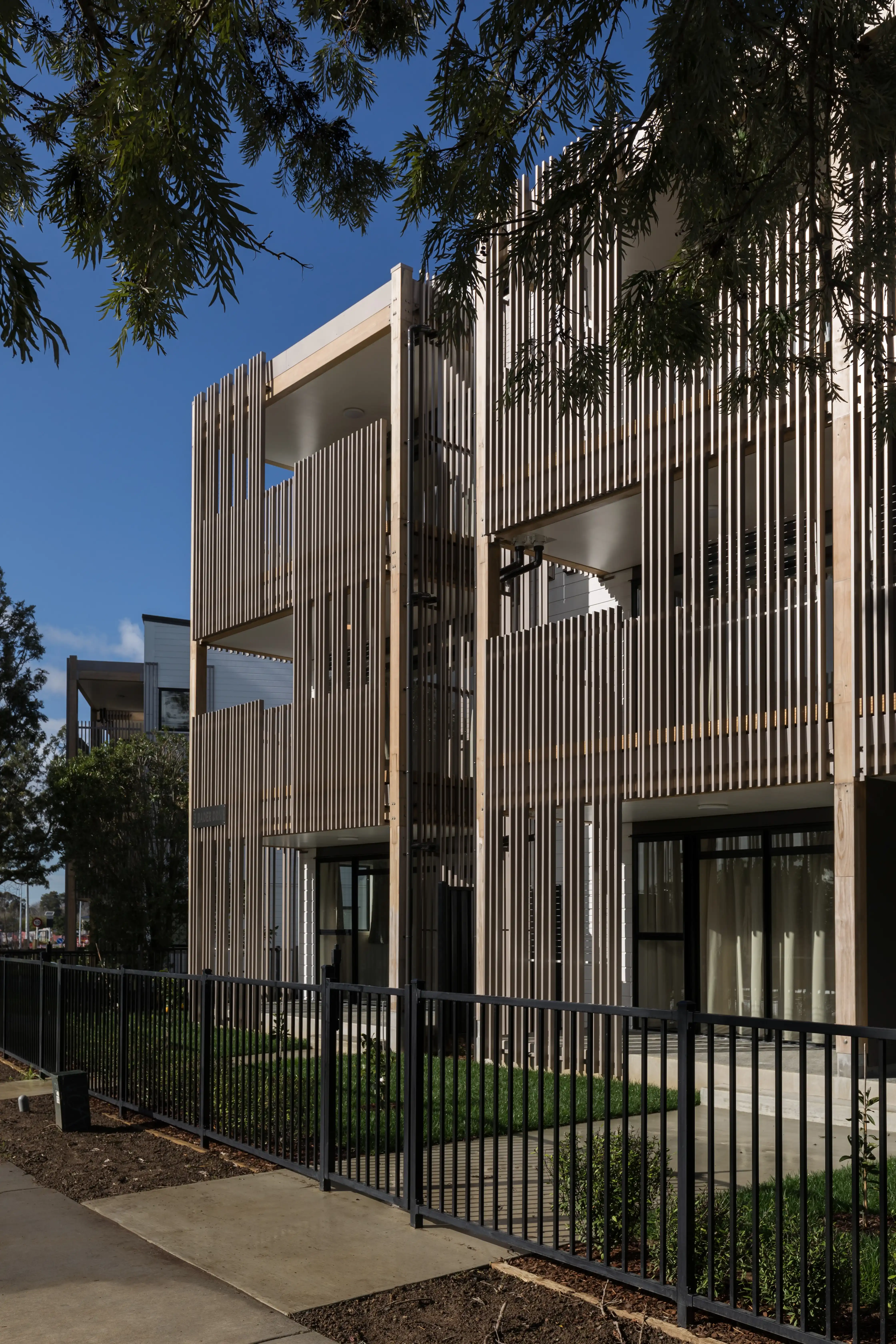 Bader Ventura streetscape, where balustrades and screens form a cohesive facade for Kāinga Ora housing