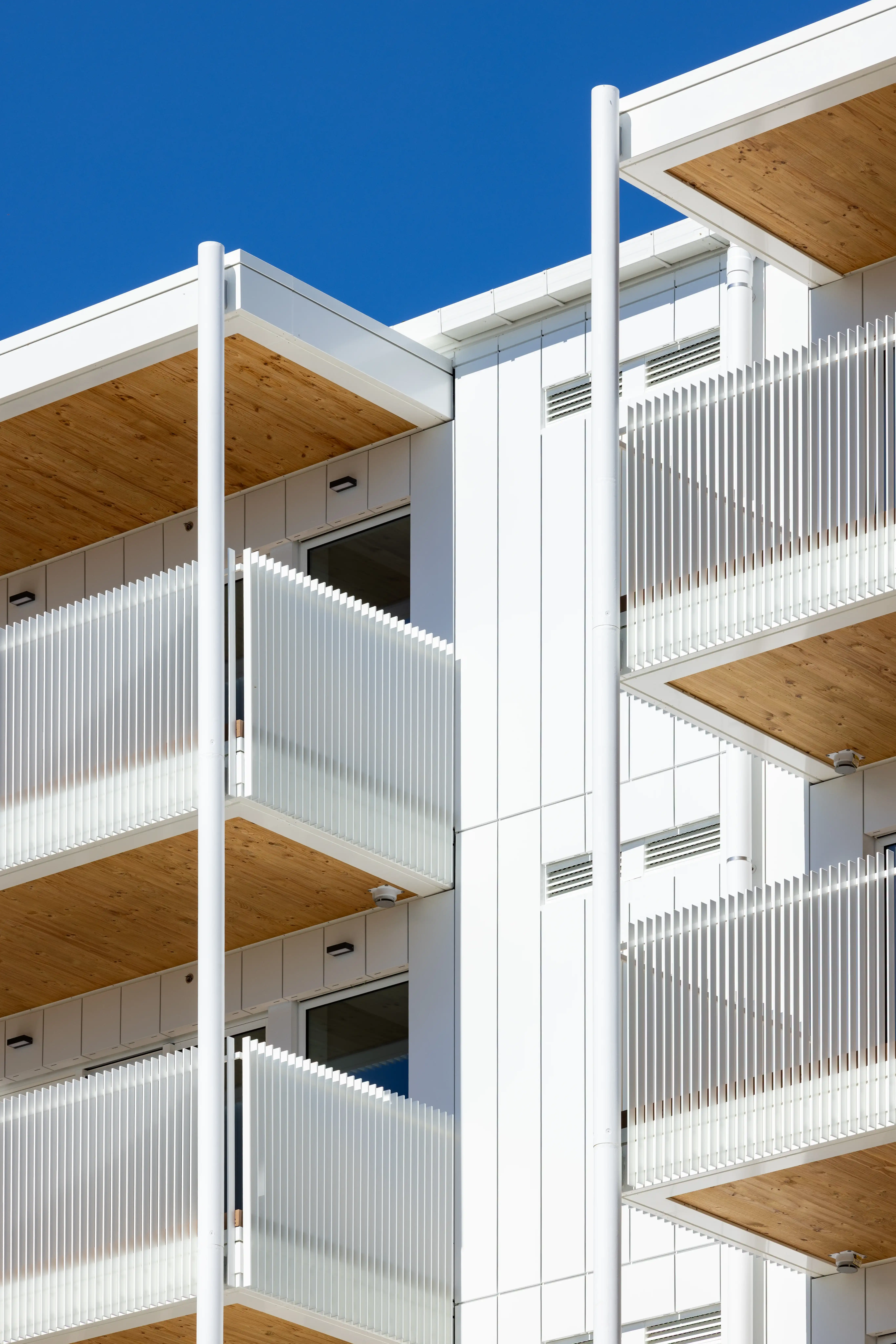 View through an aluminium balustrade from a senior apartment balcony to the communal gardens at Community Lane.