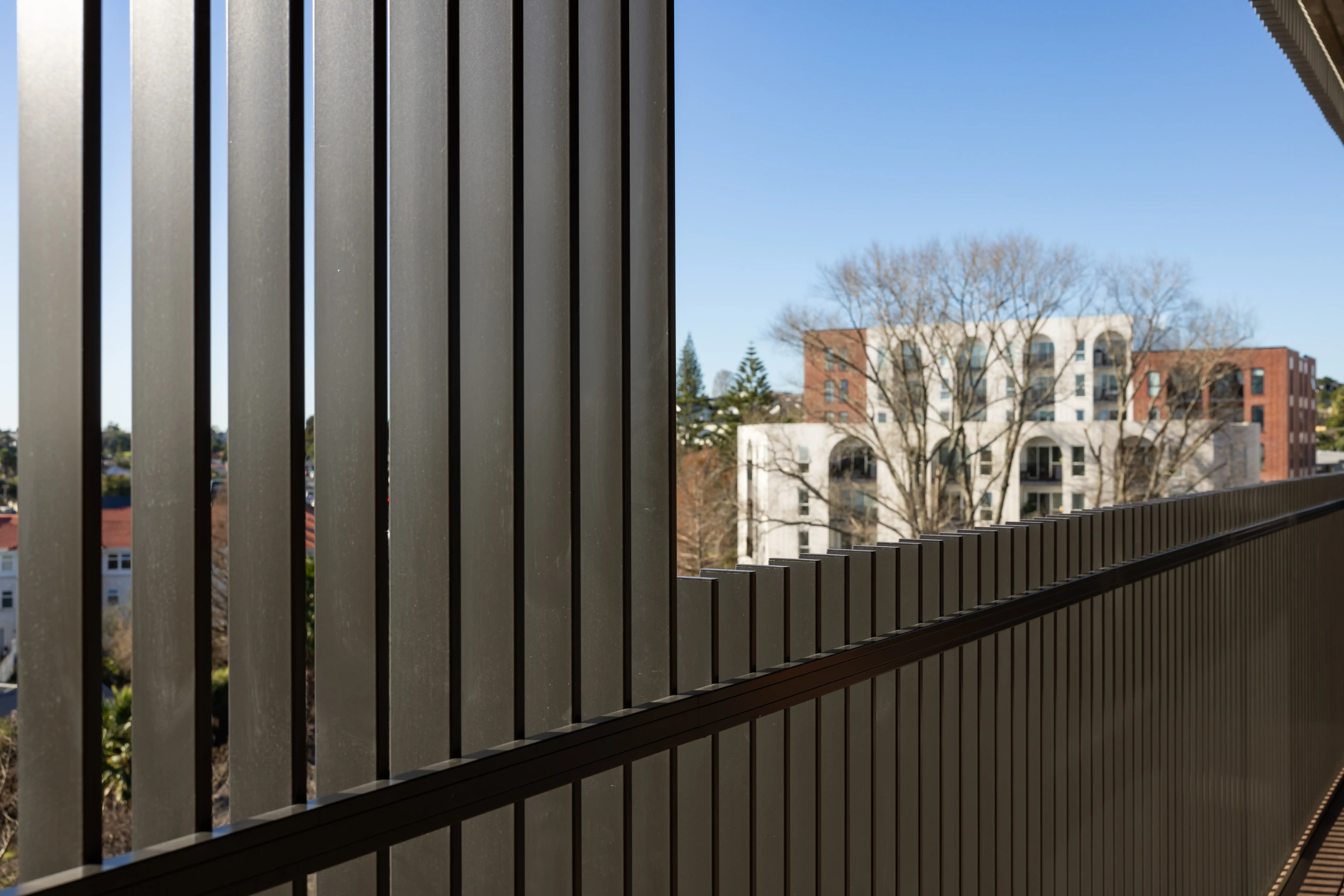 Close-up of an Attaché Affinity balustrade fixing at a precast slab edge, detailed to absorb site tolerances.