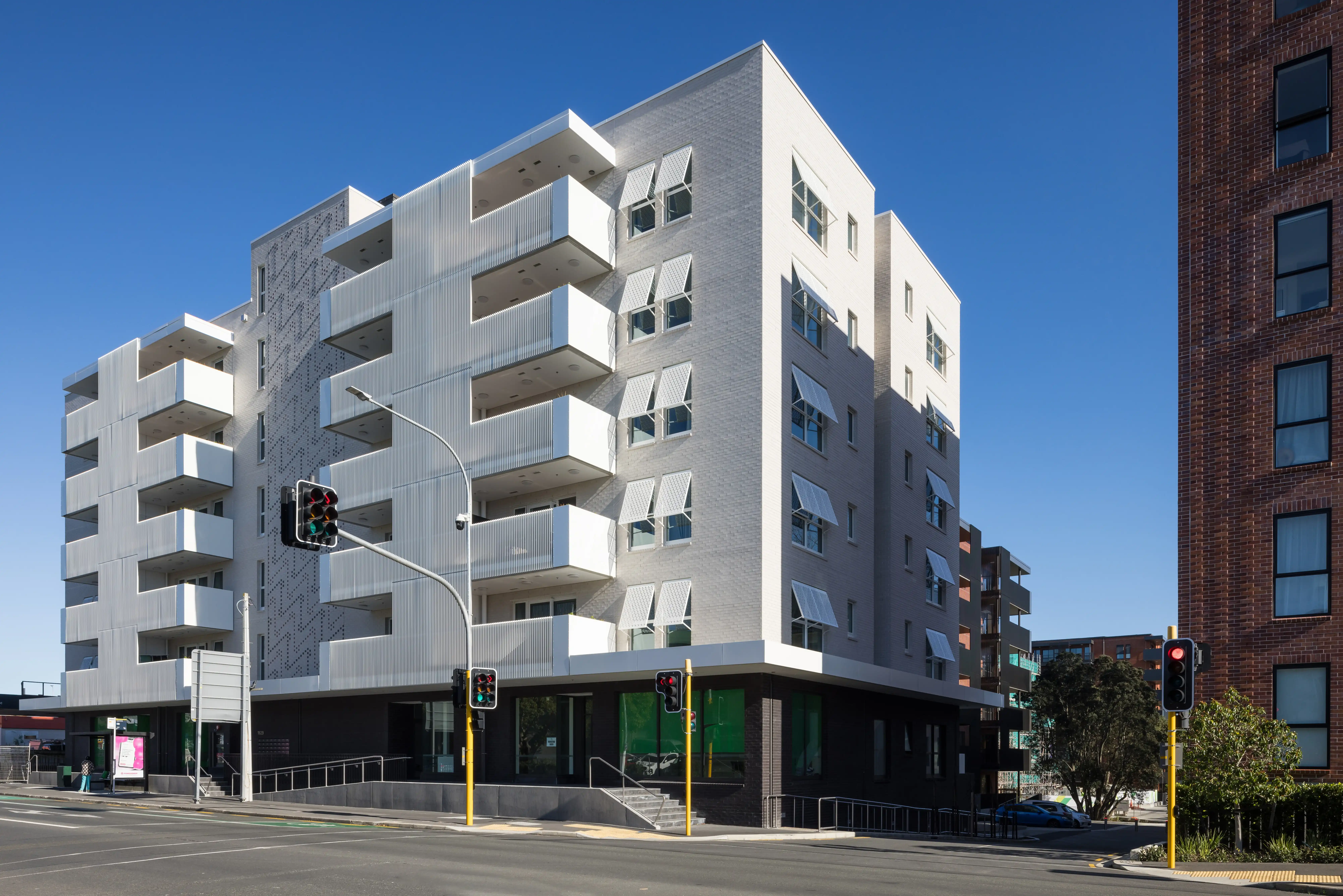 Shared gardens at Community Lane framed by apartment balconies fitted with Attaché Affinity balustrades.