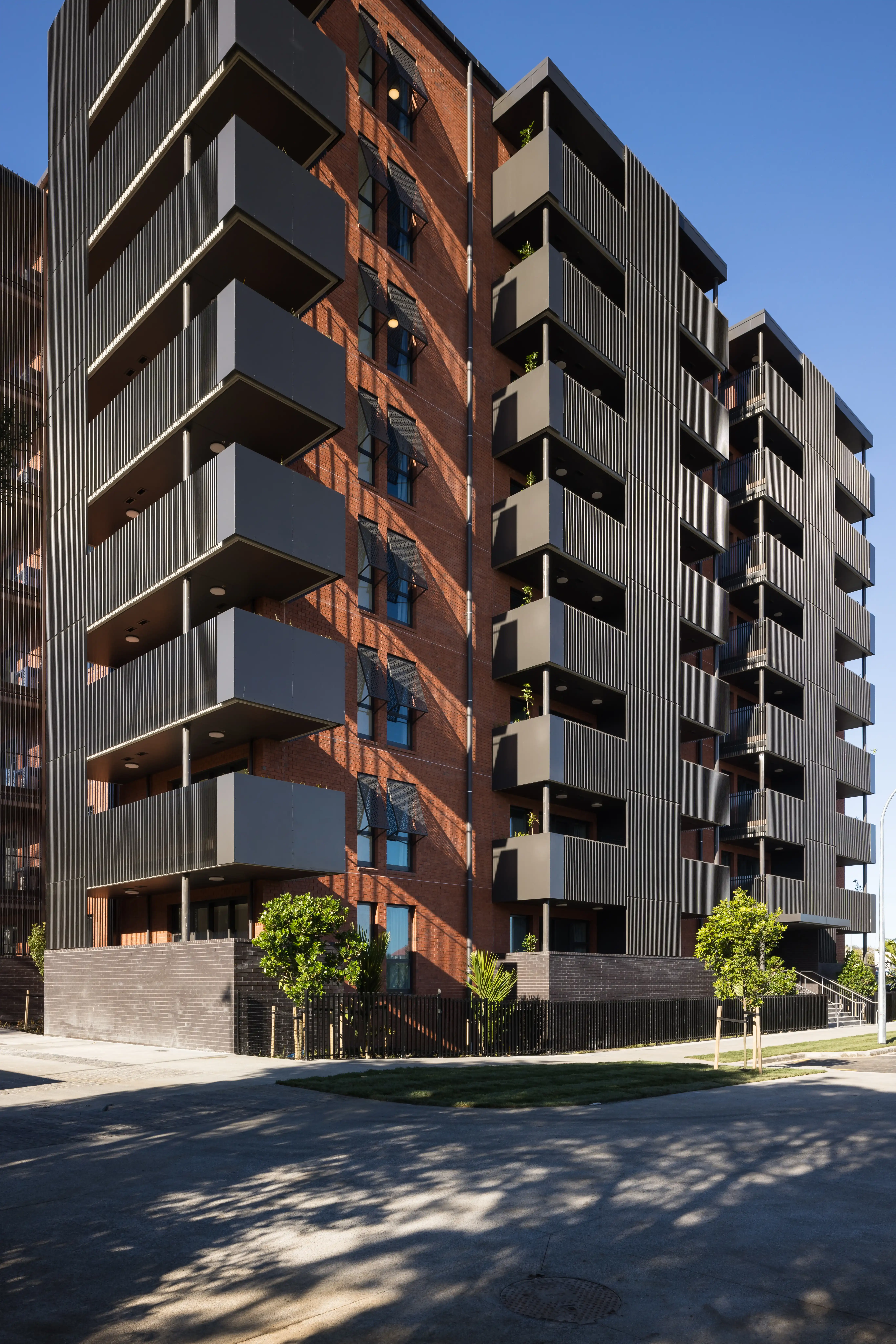 A balcony at Community Lane where senior housing balustrades and screens balance privacy and outlook.