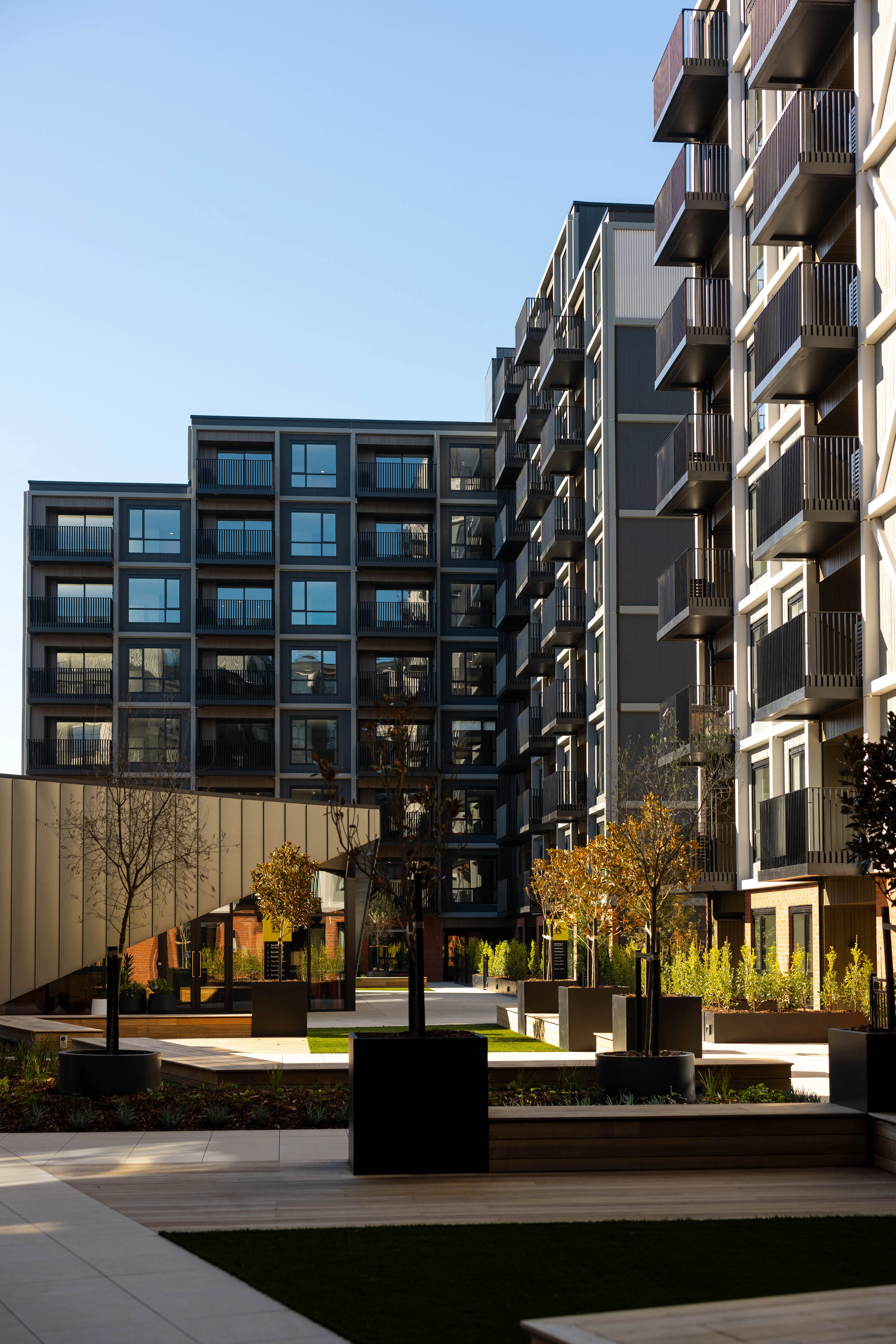 View through head-on aluminium fins from a Resido balcony out across Sylvia Park, Auckland.