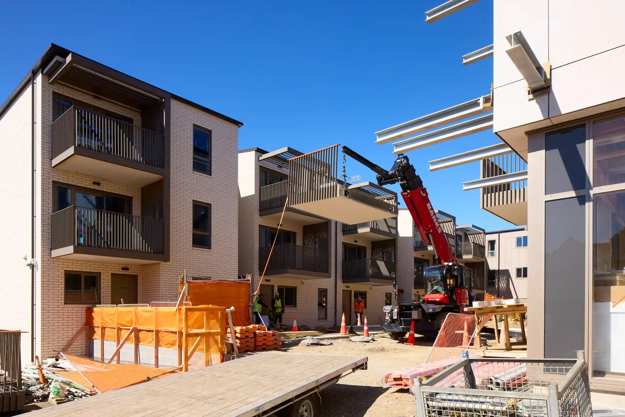 Prefabricated glide-on balconies on a Te Ō apartment block, installed once the facade was complete.