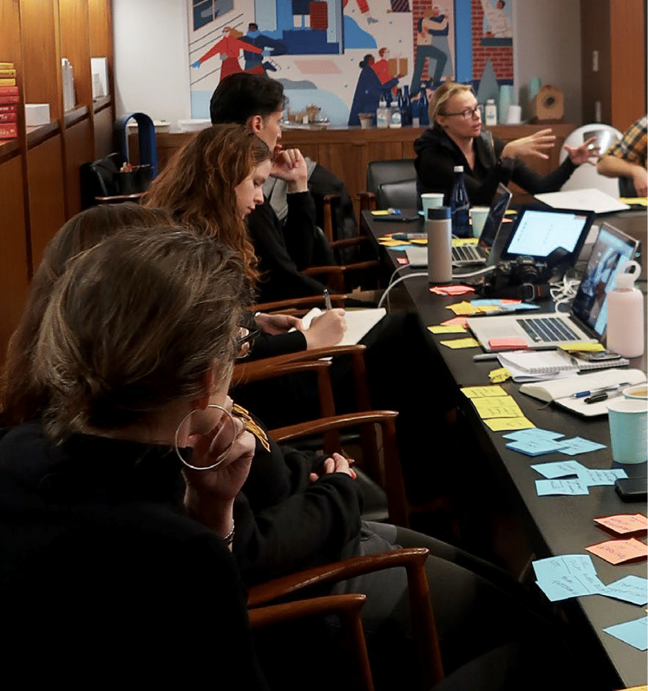 TRU2U meeting with participants seated around a table, engaged in discussion.