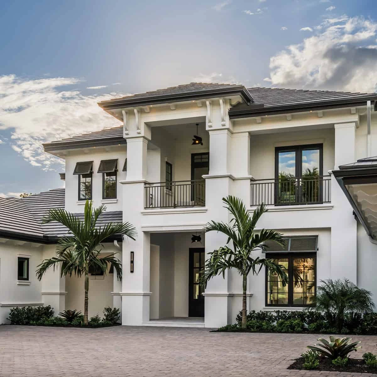 Contemporary luxury kitchen with walnut cabinetry, built-in wine cooler, white upper cabinets, quartz countertops, and Wolf appliances — designed and built by Rheace Contracting in Palm Beach County.