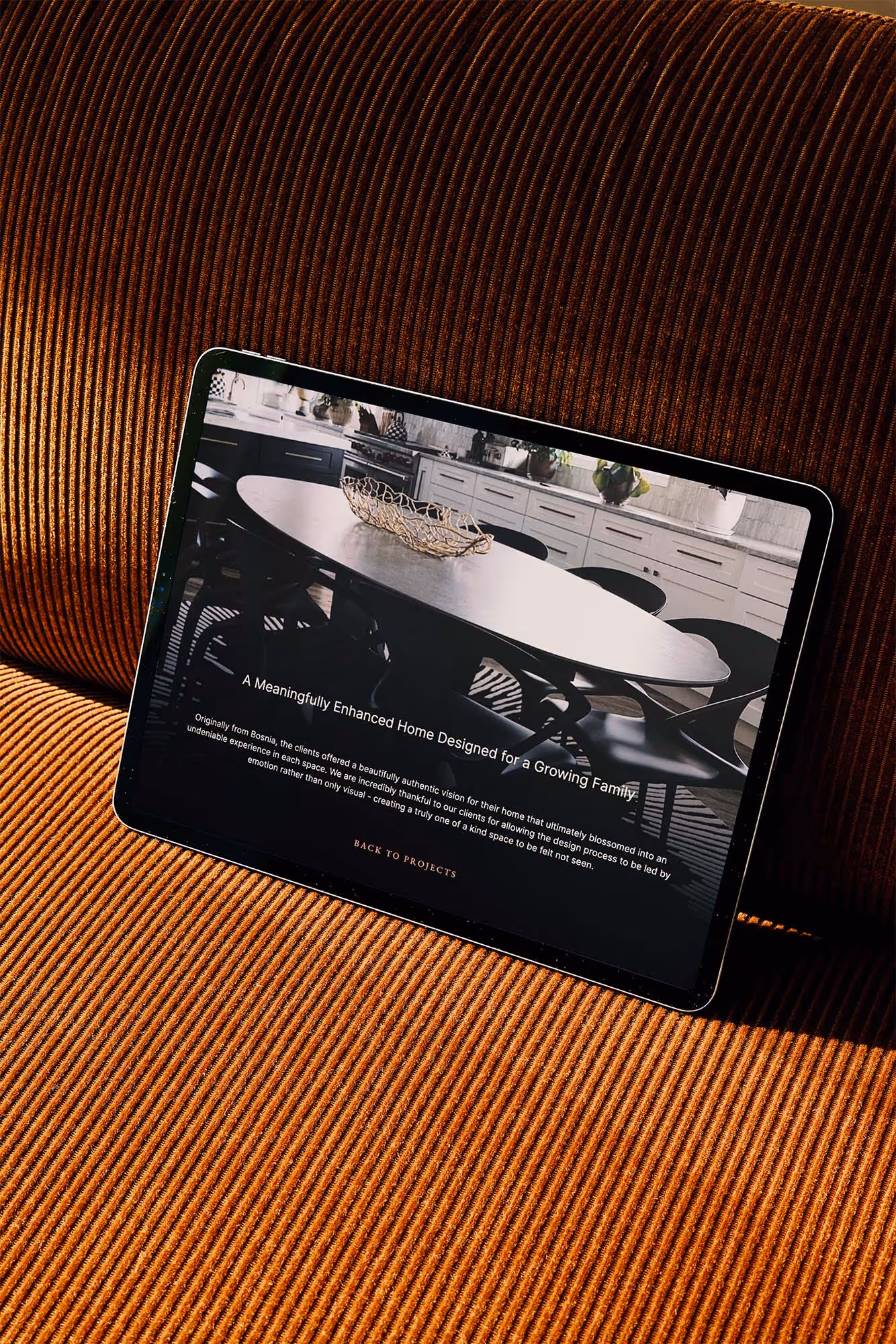 tablet on orange couch