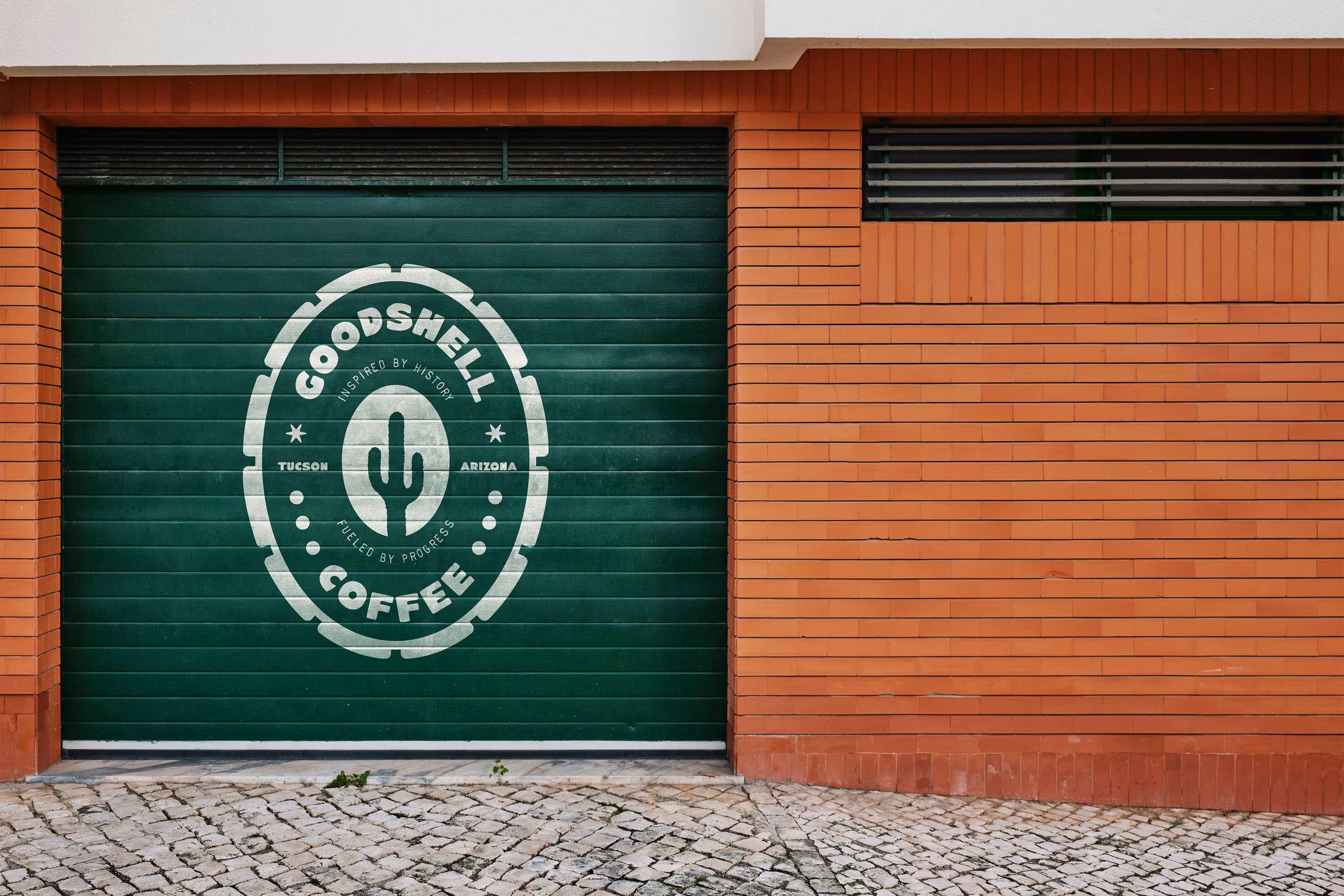 brick building with green garage door