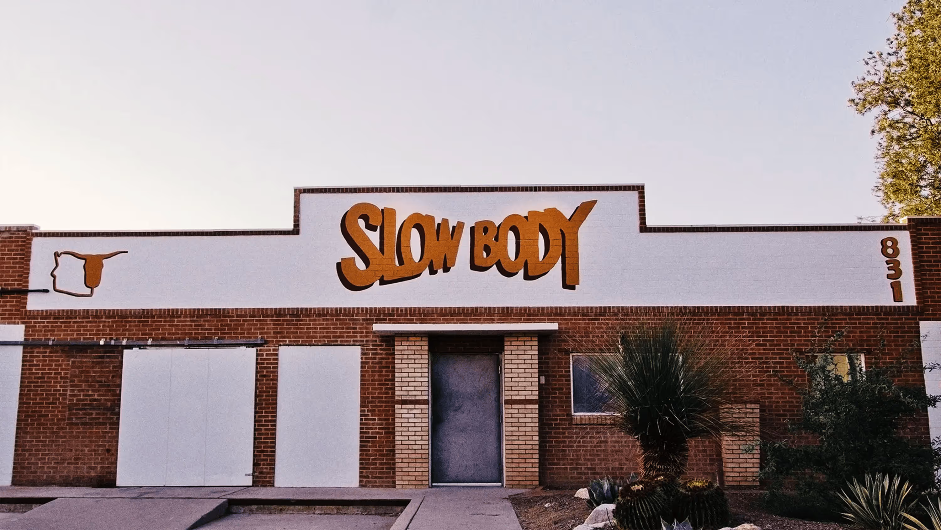 white brick brewery storefront at dusk
