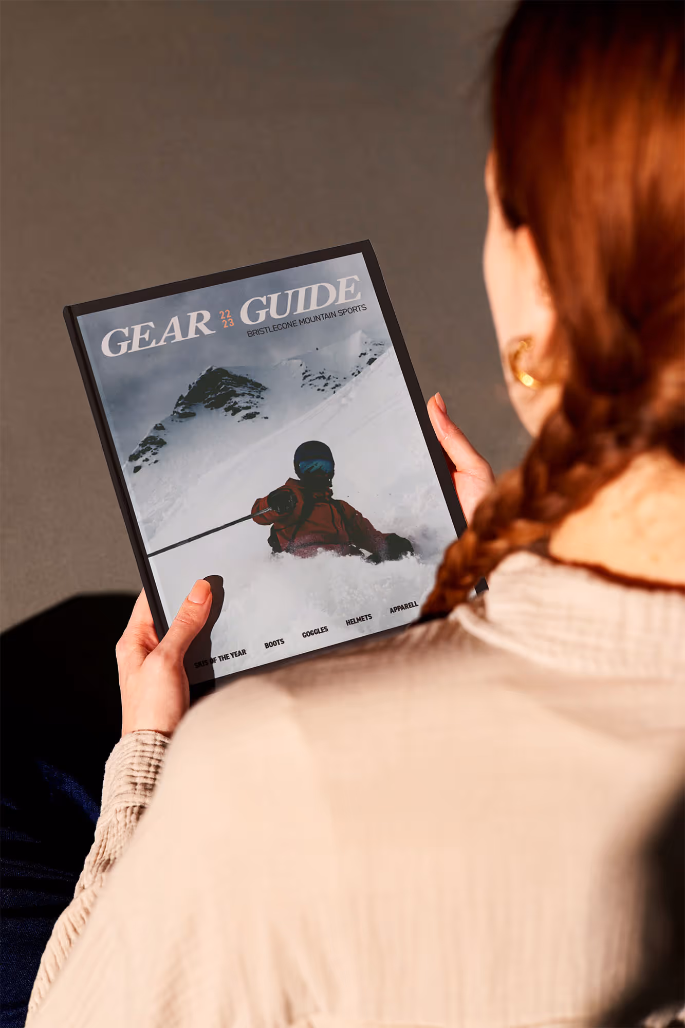woman sitting down and reading a gear guide