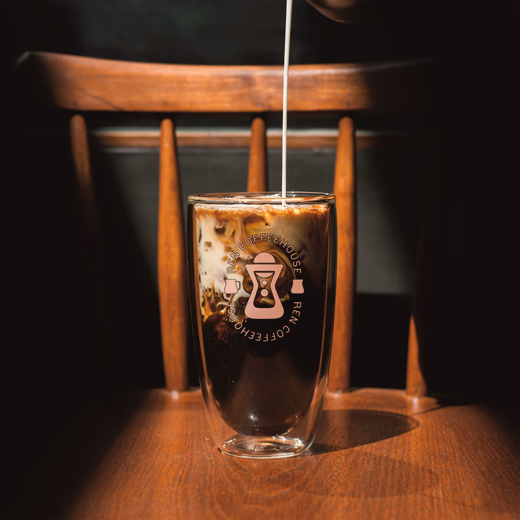 glass of iced coffee on a wooden chair