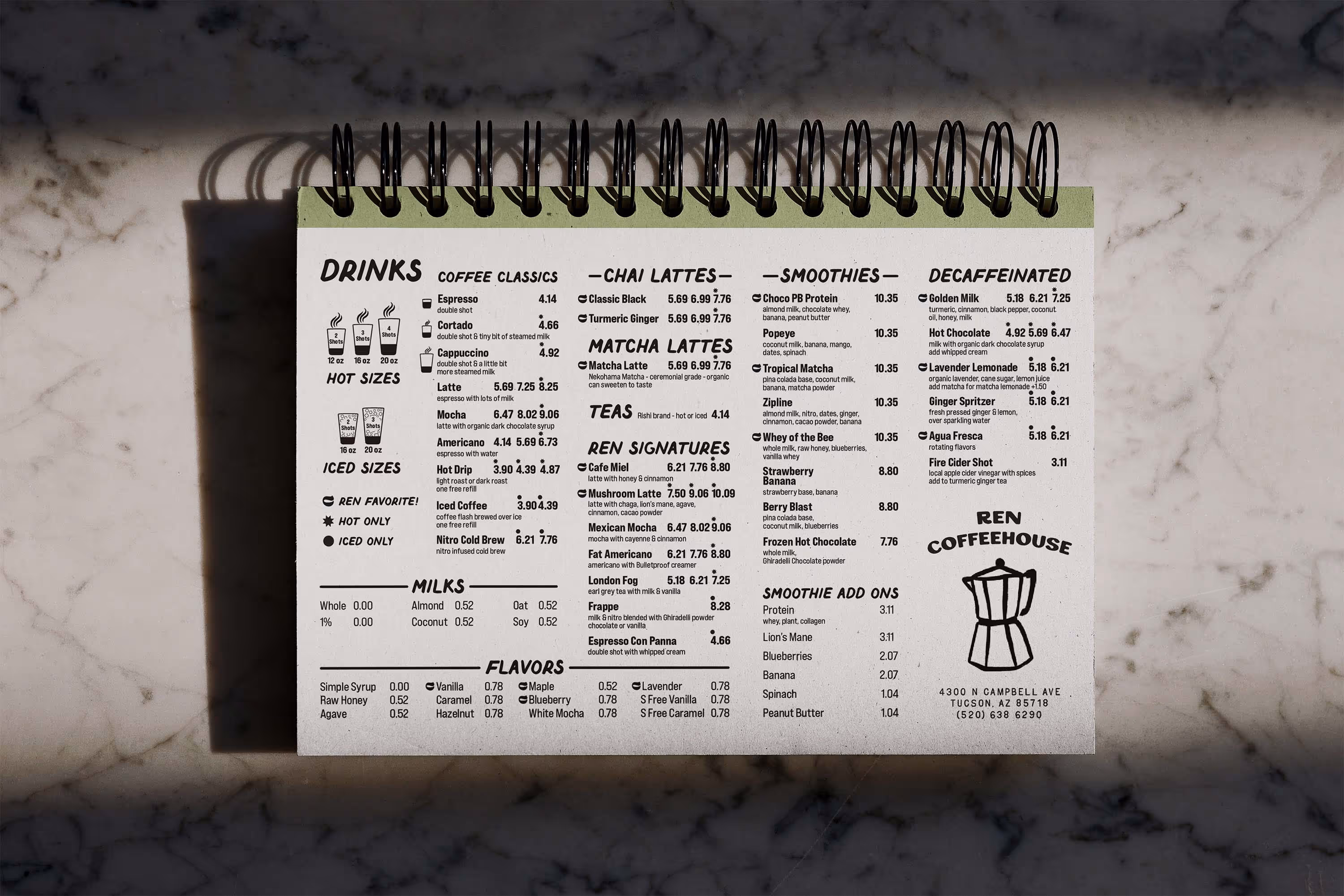 cafe menu in spiral notebook on stone countertop