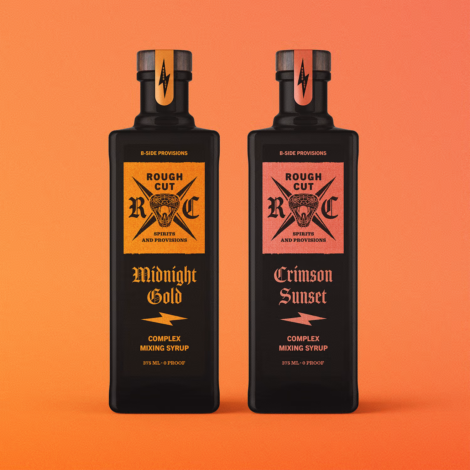 Two black rectangular bottles of Rough Cut complex mixing syrup on an orange background; the left bottle is labeled Midnight Gold with an orange label and the right bottle is labeled Crimson Sunset with a red label.