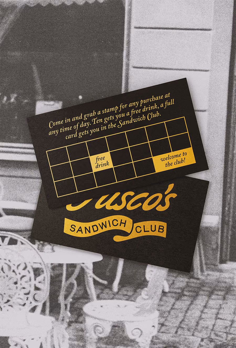 Black membership card with gold foil typography on vintage photograph background