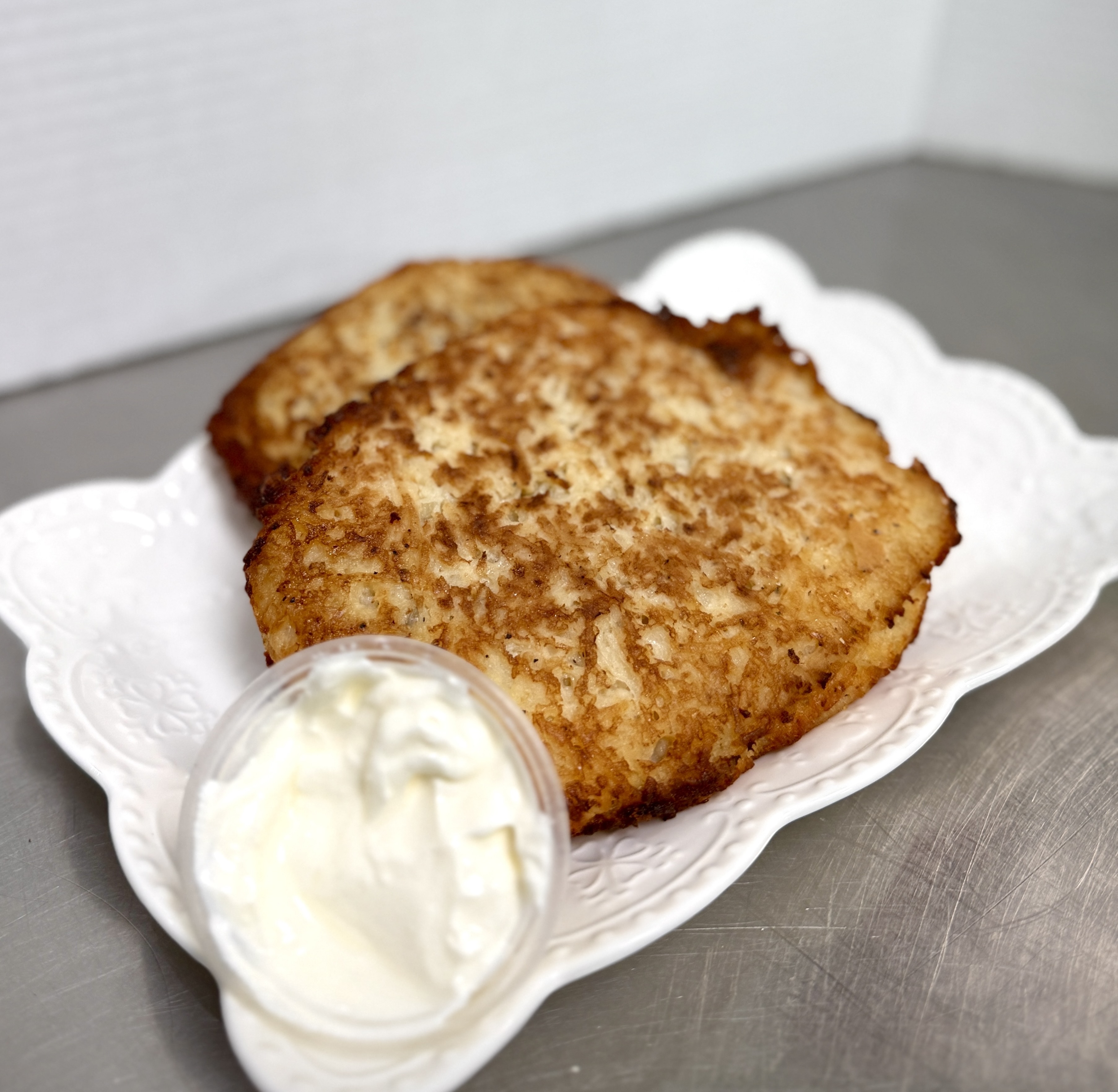 Positive young multiracial friends eating fast food and drinking beer in outdoor cafe