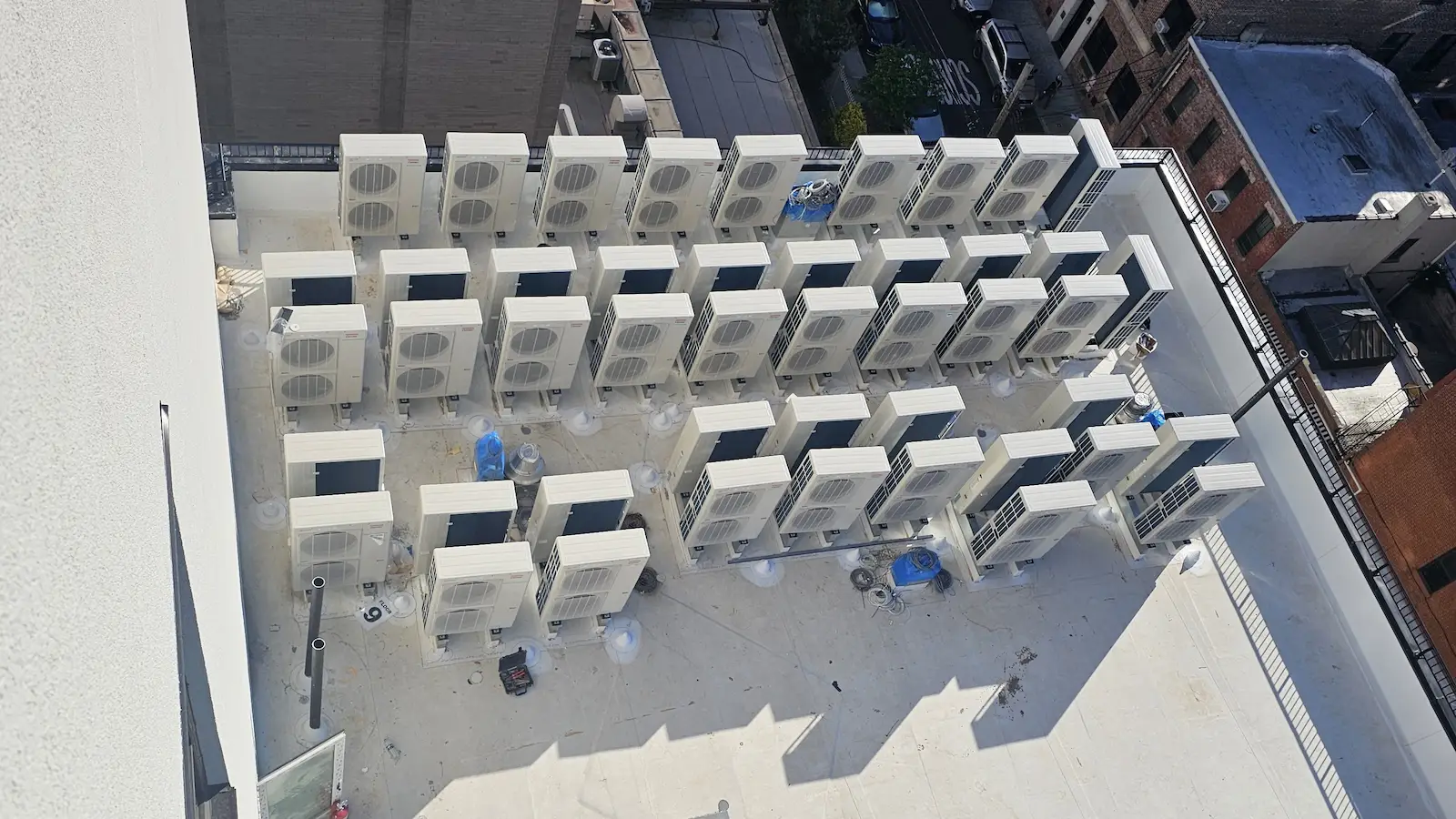 Aerial view of 68 commercial VRF HVAC units installed on a rooftop in Astoria, New York