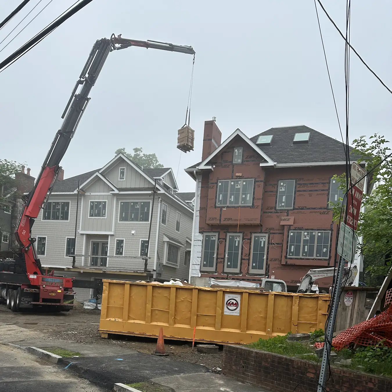 HVAC unit being lifted by crane during residential installation in Greenwich, Connecticut