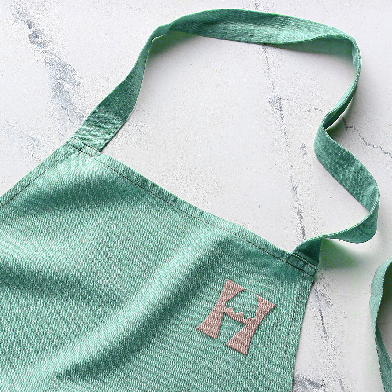 harpers monogram logo on apron