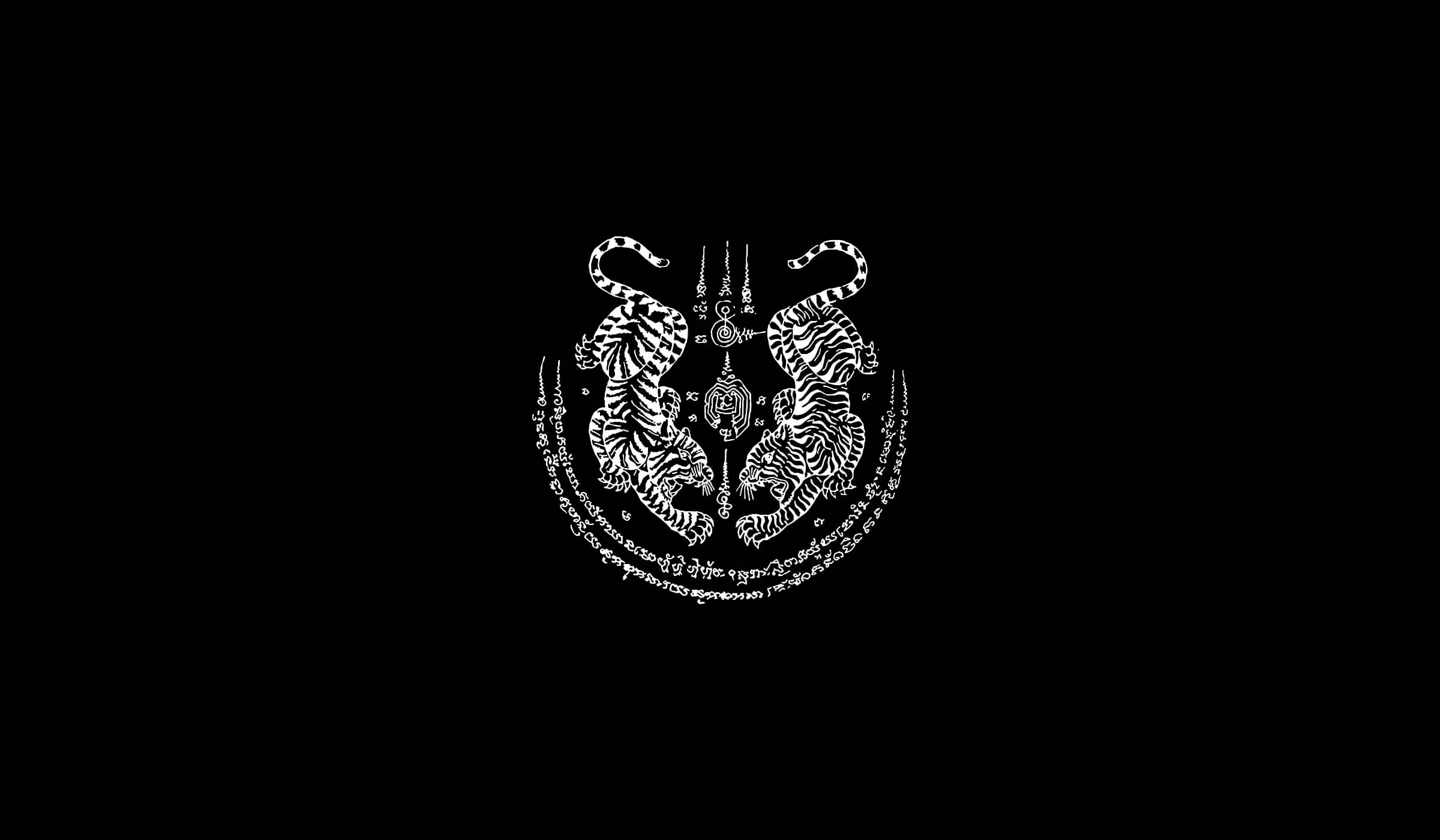 Sacred Thai tattoo artwork with twin tigers and ancient script used in Muay Thai symbolism