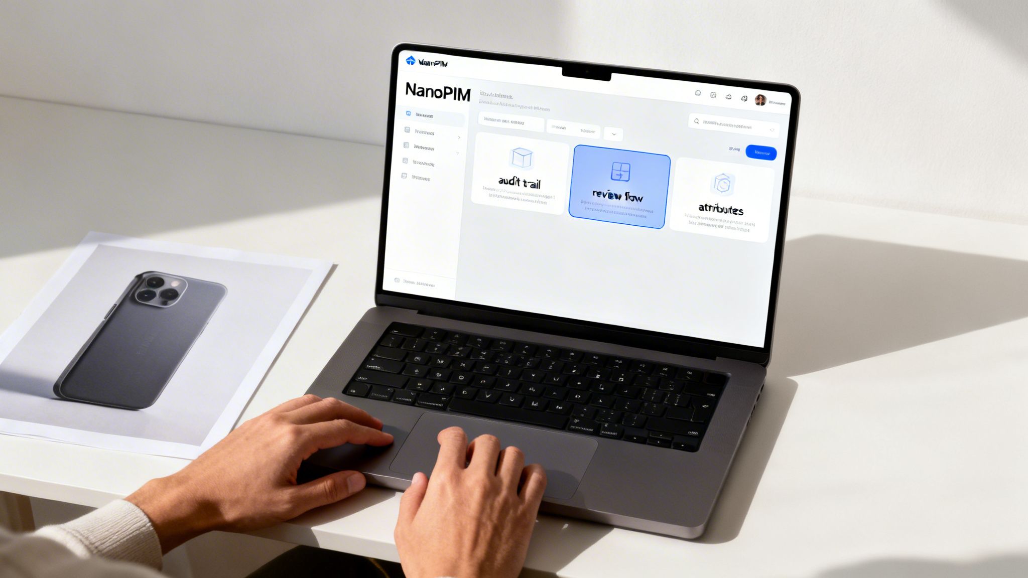 Hands typing on a laptop displaying NanoPIM software with data management features on a desk.