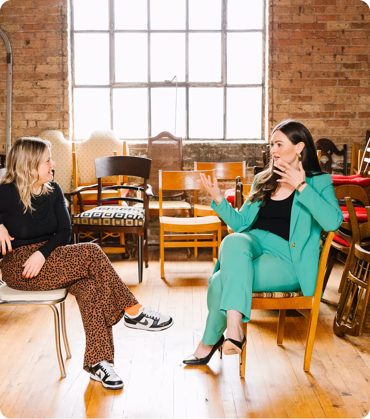 Two women sitting on chairs and talking