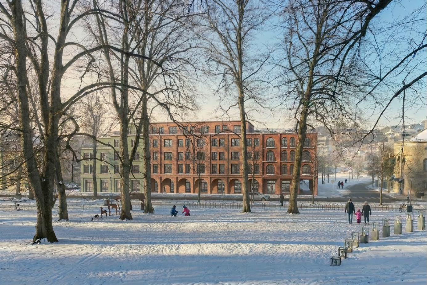 Snødekket park som viser boligprosjekt i mursten fra perspektiv gjennom parken
