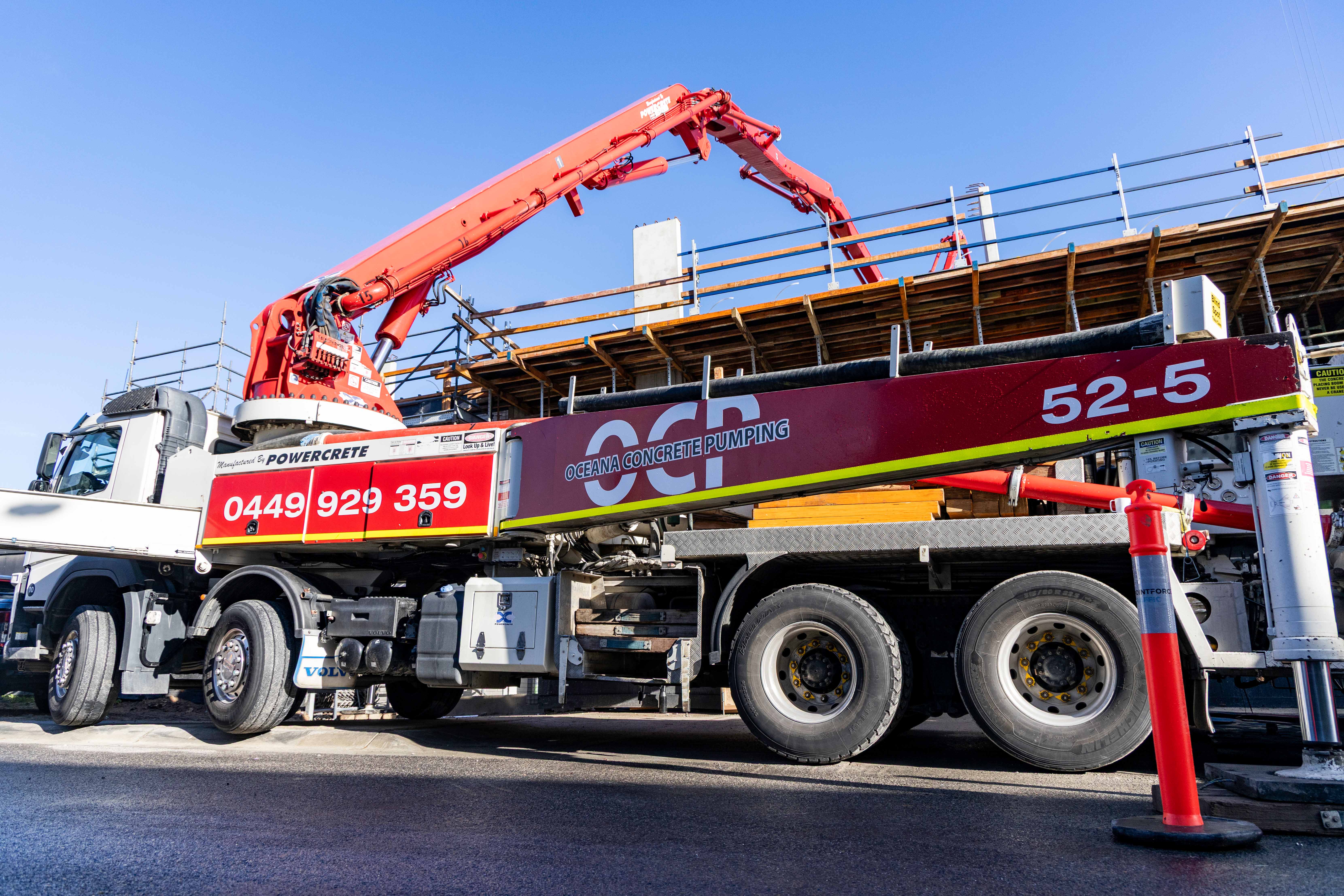 Oceana Concrete Pumping line pump truck on a Melbourne construction site with crew members on-site.