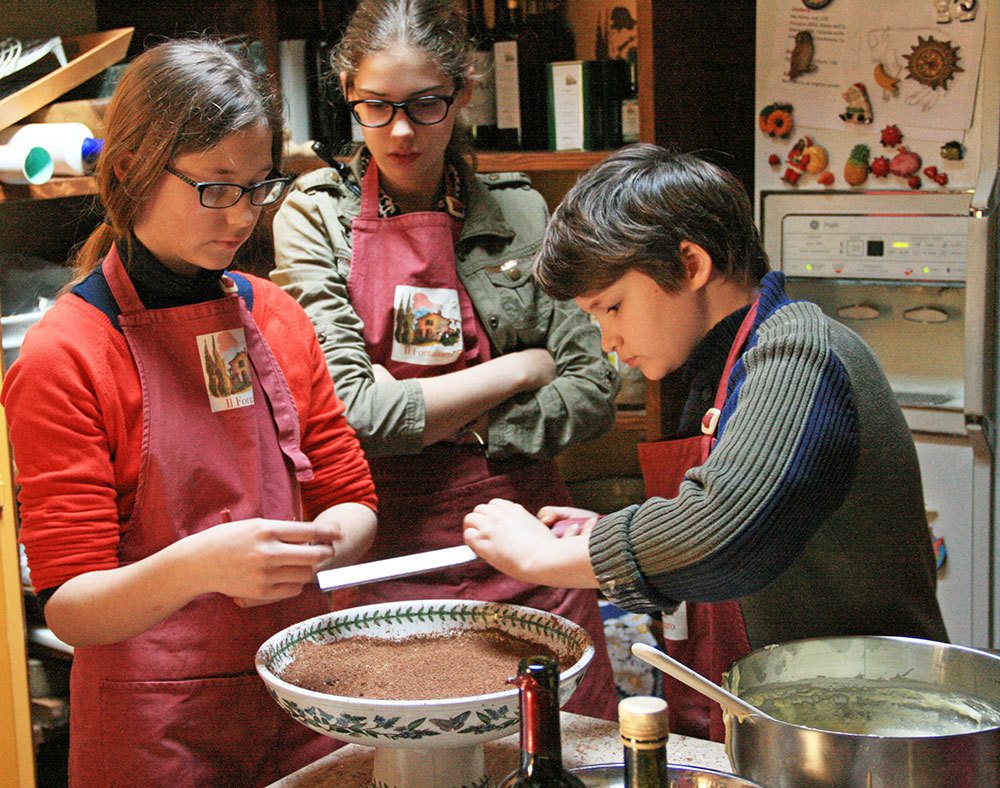 Kids shaving Balinese chocolate on Tiramisu in Italy