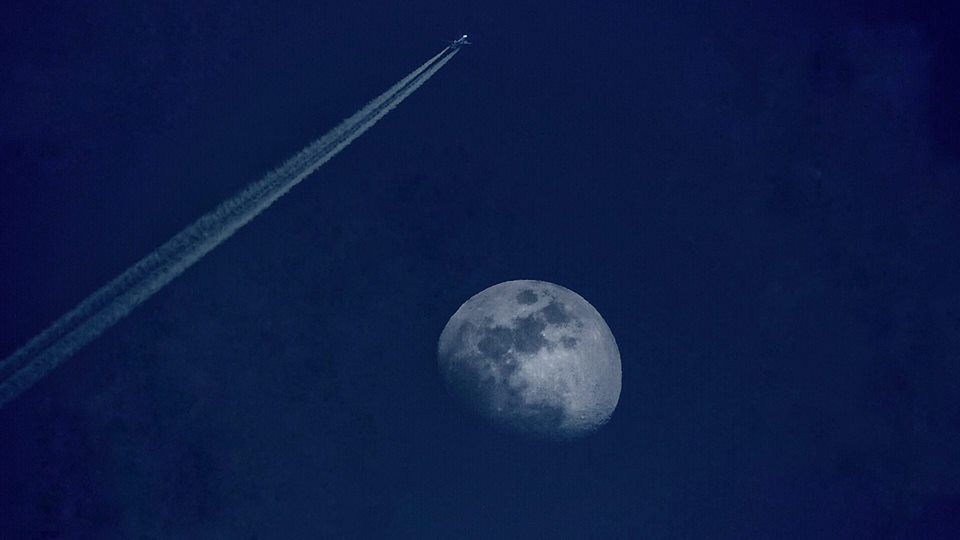 plane and moon. Photo by Kristian Presnal. 
