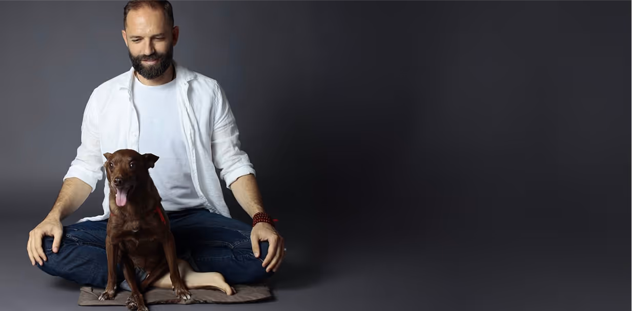 Angelo Vaira medita con un piccolo cane