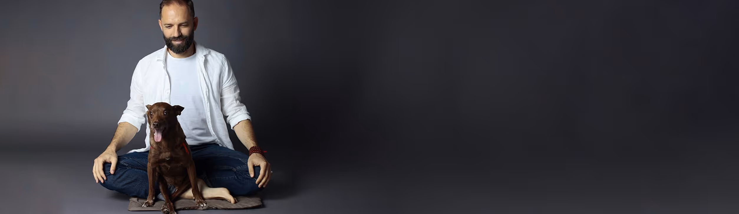 Angelo Vaira medita con un piccolo cane