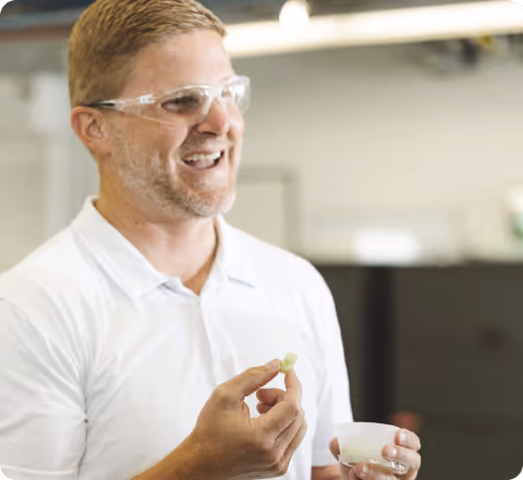 Biotech researcher evaluating gene-edited plant sample in laboratory environment
