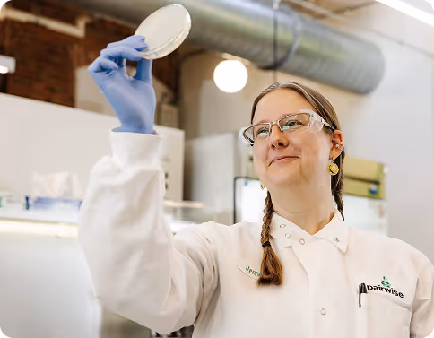 Smiling researcher examining results in a biotech lab focused on food innovation