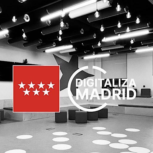 Modern indoor auditorium with circular seating, ceiling lights, and Digitaliza Madrid logo overlay with red flag featuring seven white stars.