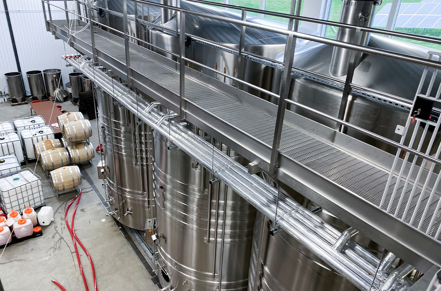 Inside building at a vineyard with large vats