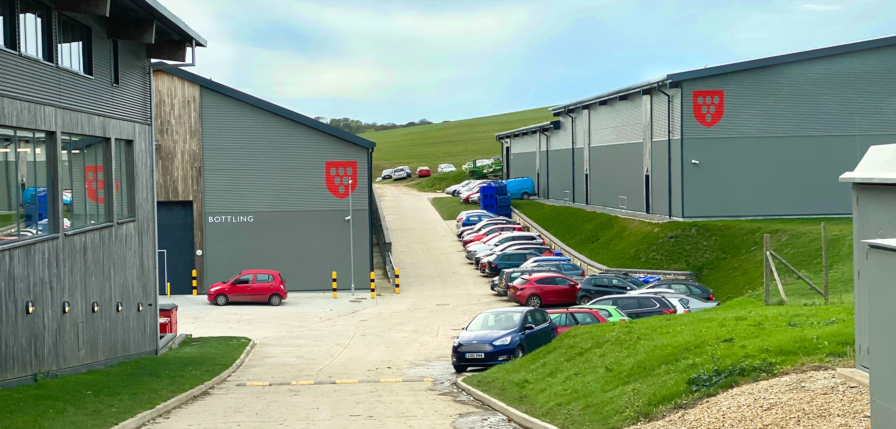 Grey warehouses and a car park