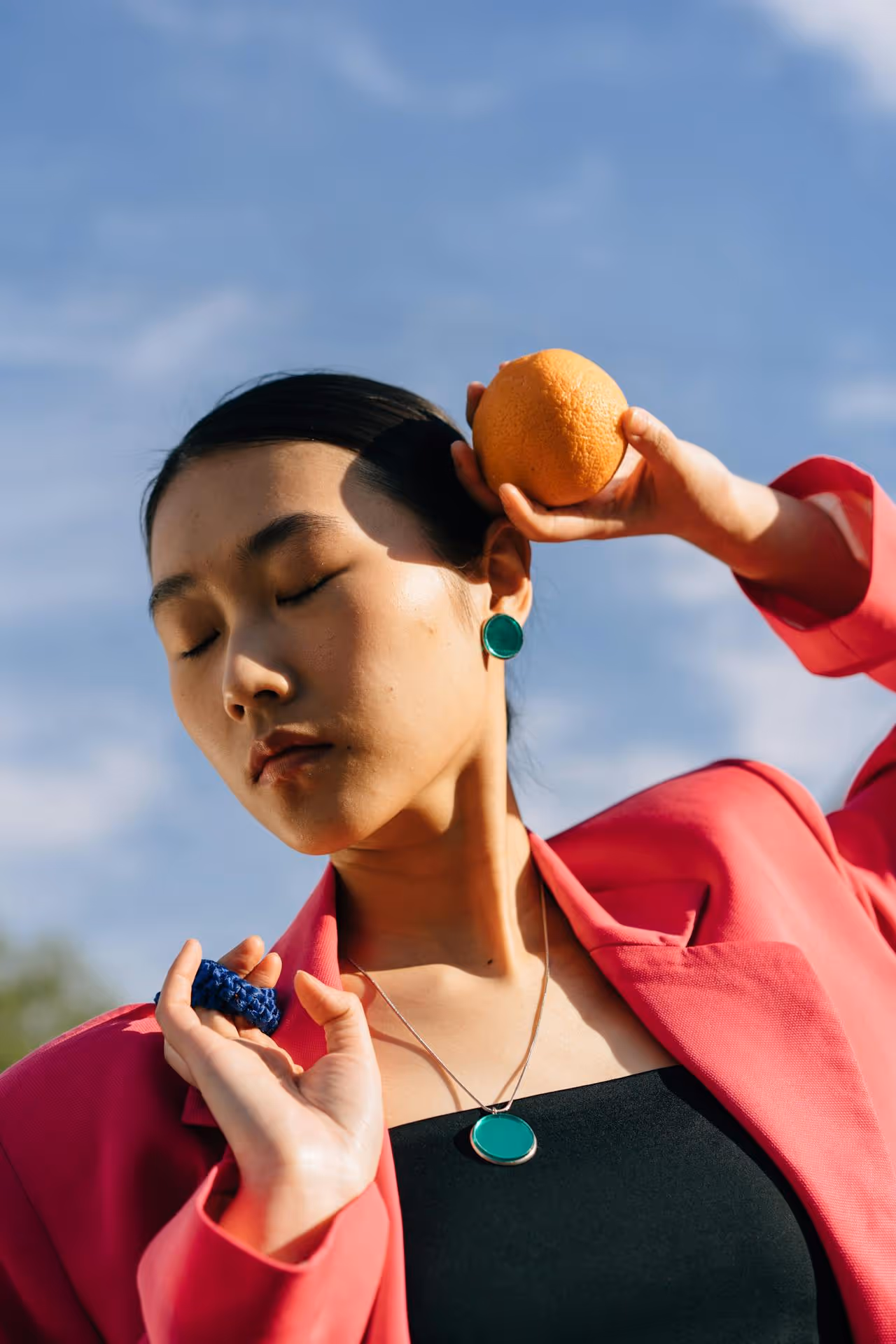 Image of a woman holding an orange.