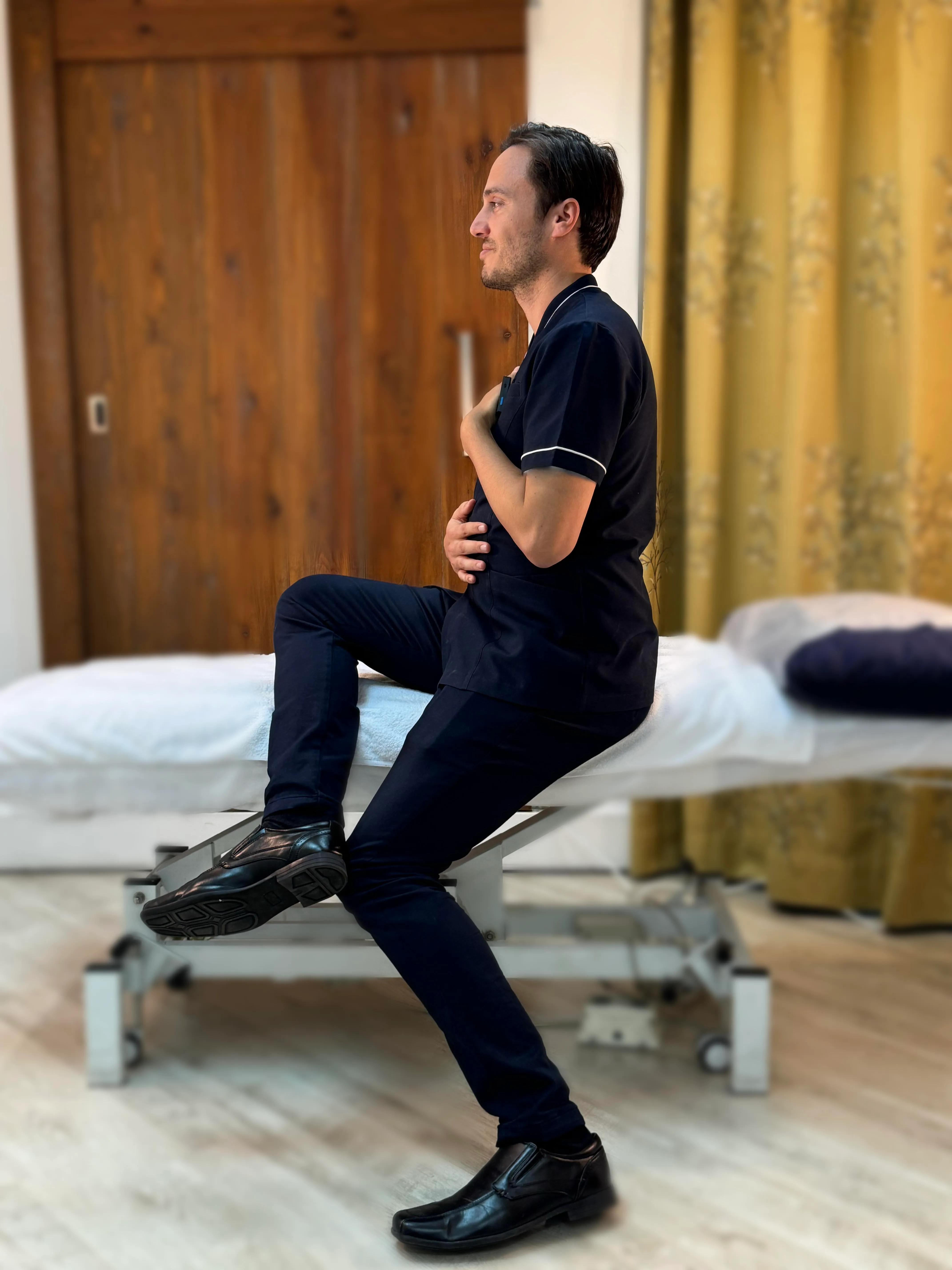 Osteopathic practitioner at City Osteopathy demonstrating movement assessment and rehabilitation exercise, showing the clinic's integrated approach to understanding body mechanics and functional movement for comprehensive patient care