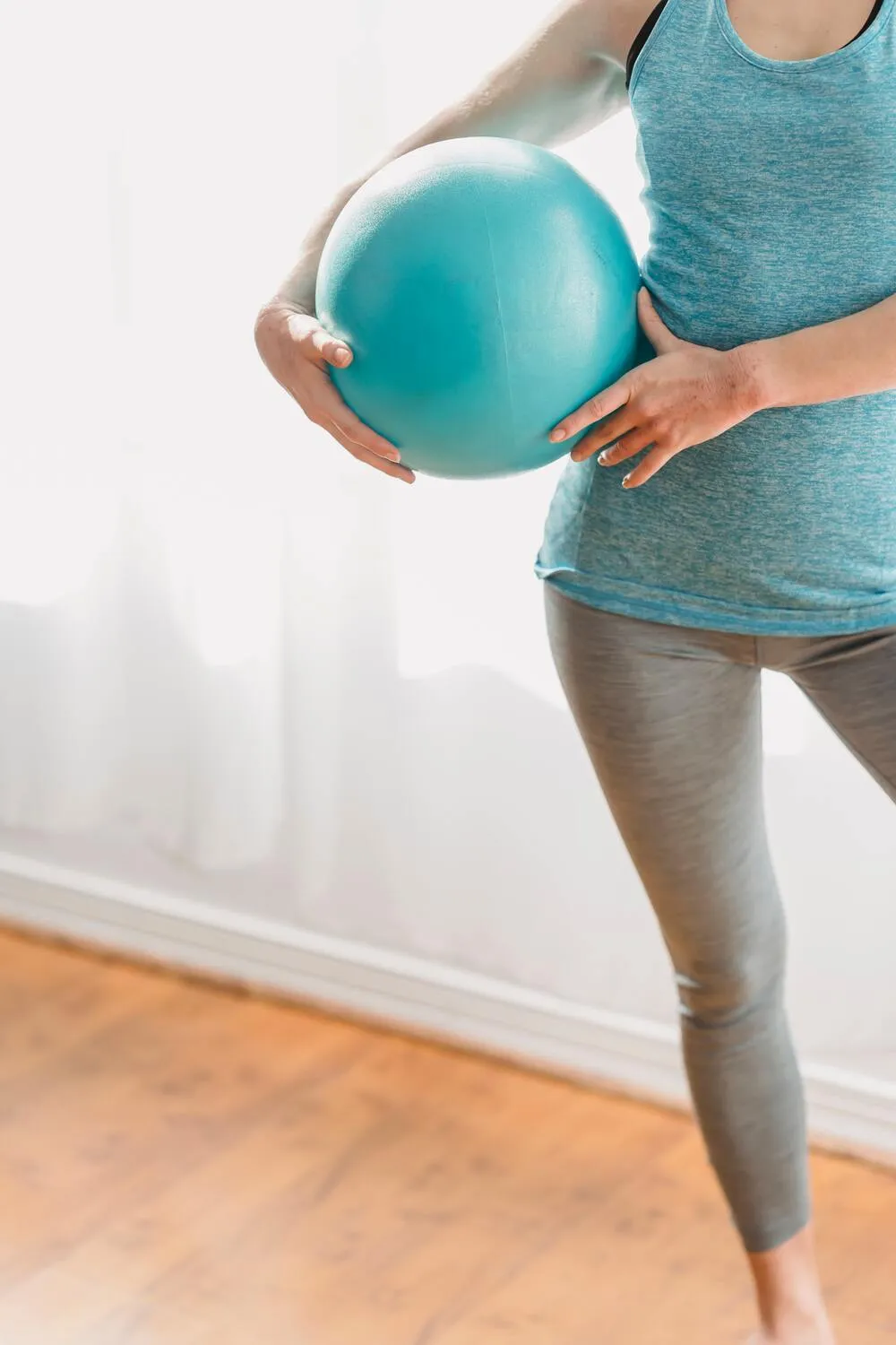 1:1 Pilates session at City Osteopathy showing client performing personalized exercise with Pilates ball, demonstrating the clinic's tailored movement rehabilitation approach for strength, mobility and conditioning