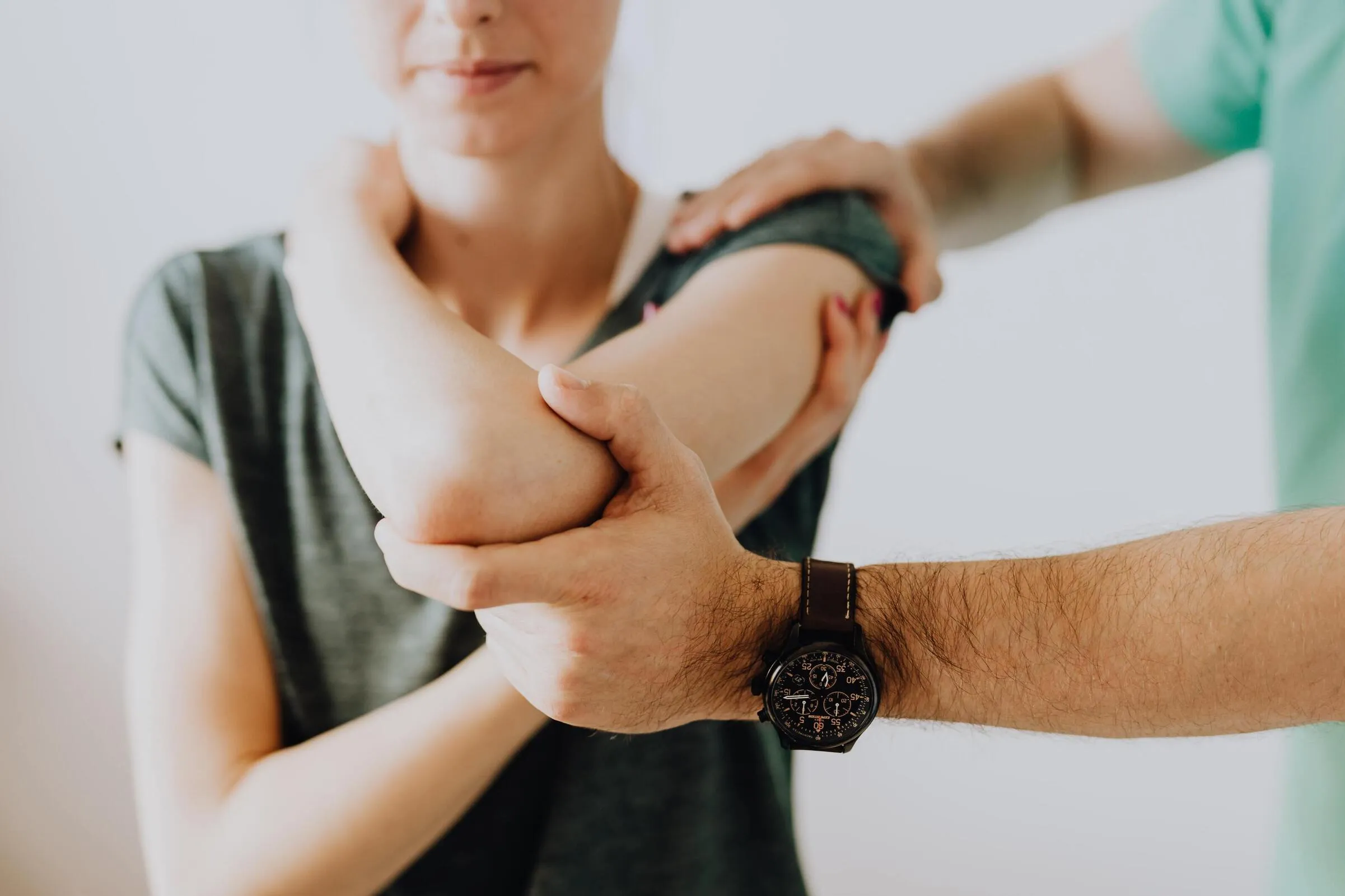 Osteopathic treatment at City Osteopathy showing practitioner performing manual therapy on patient's arm and shoulder, demonstrating the clinic's hands-on approach for treating upper limb pain and mobility issues