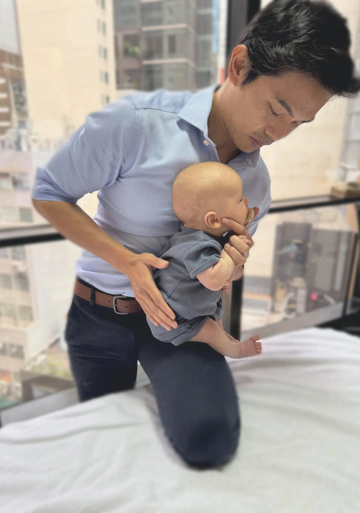 Paediatric osteopathy treatment at City Osteopathy showing practitioner providing gentle care to infant, demonstrating the clinic's advanced osteopathic care for children's unique developmental needs and comfort