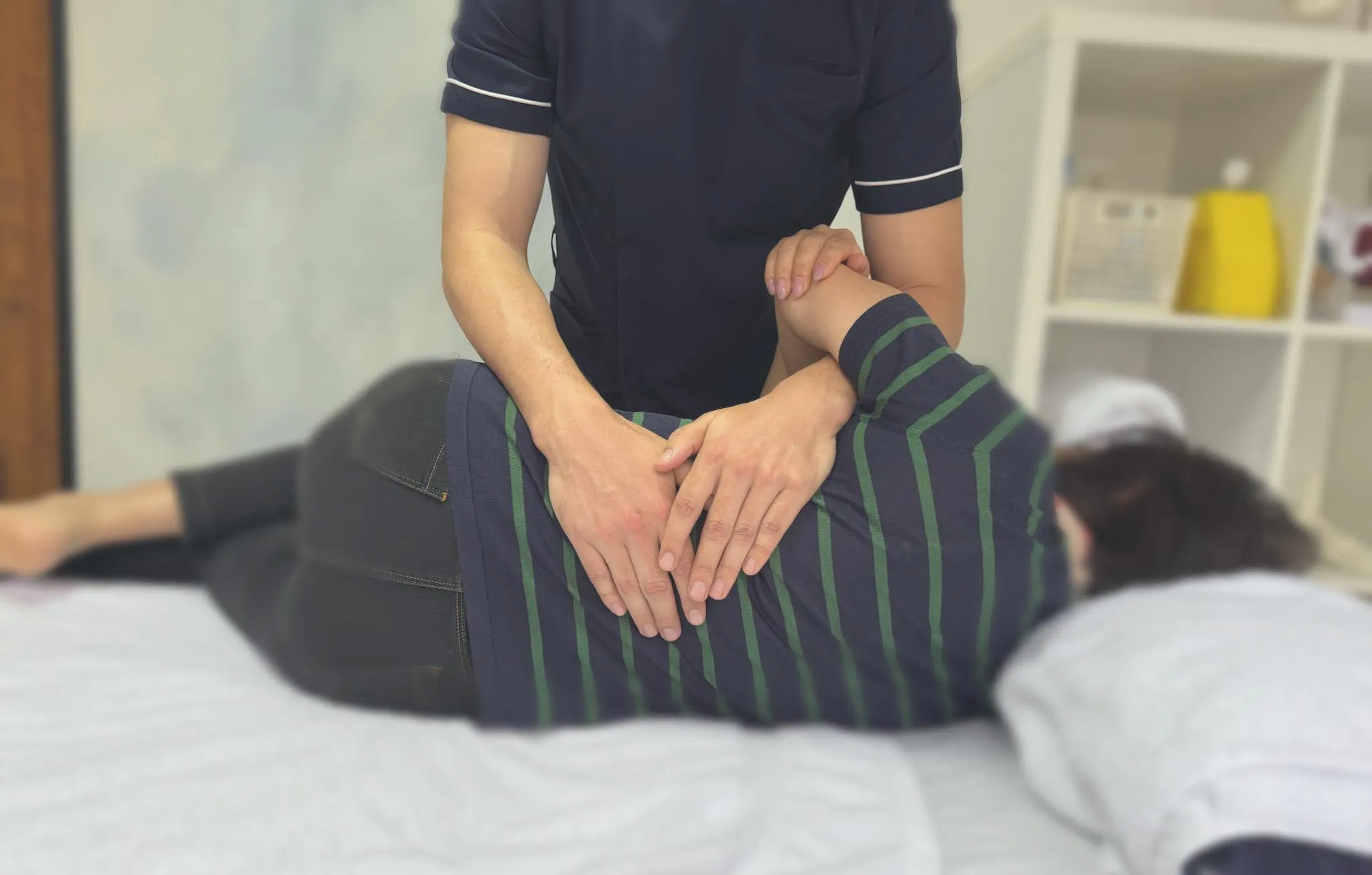 Osteopathic practitioner at City Osteopathy performing gentle manual therapy on patient's back, demonstrating the clinic's non-invasive treatment approach for spinal alignment and pain relief