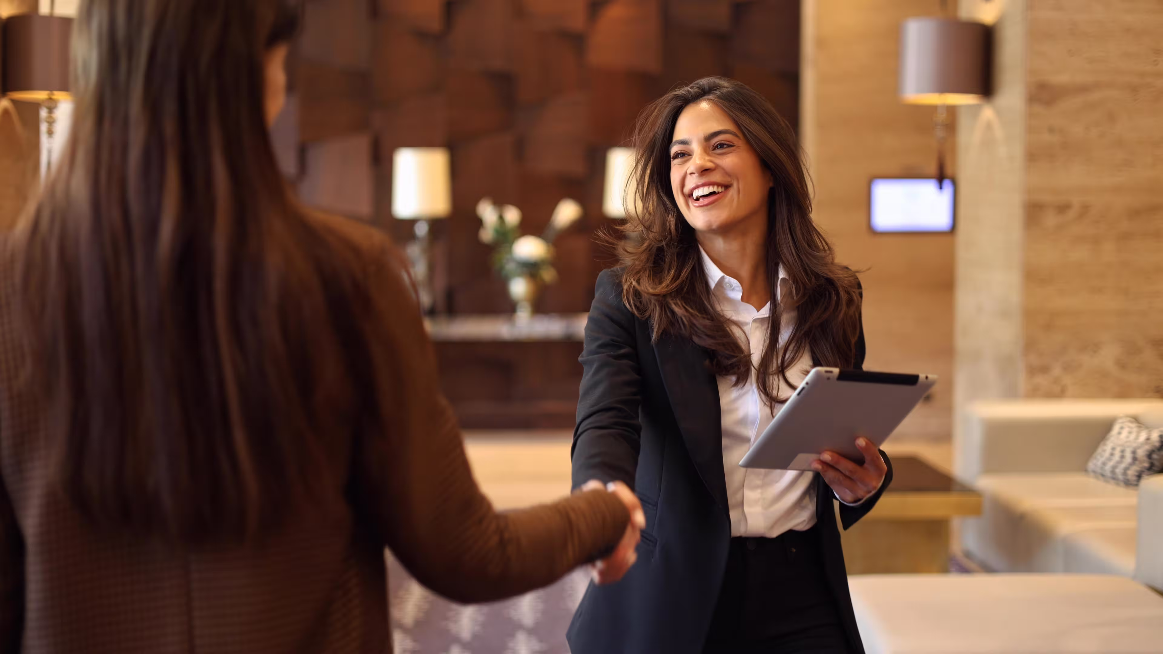 A manager shaking hands with an employee.