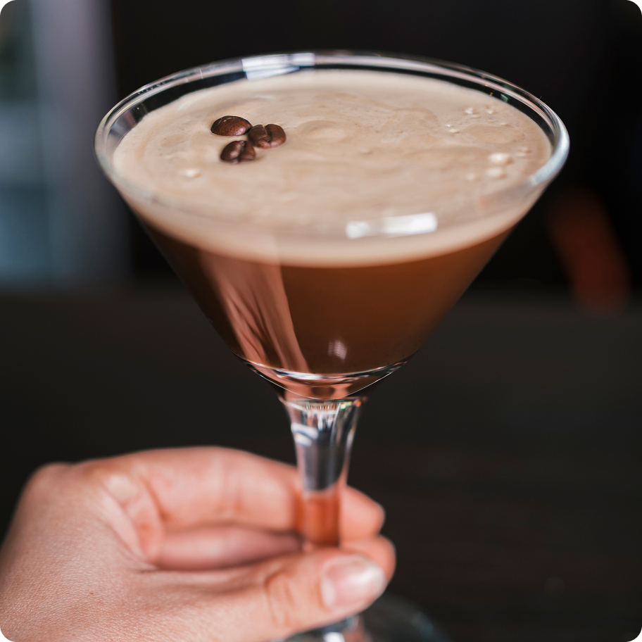 An expresso martini cocktail made by Kosto served in a martini glass.