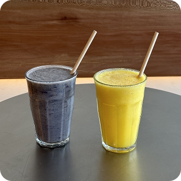 Vibrant blend: purple and yellow smoothies served fresh.