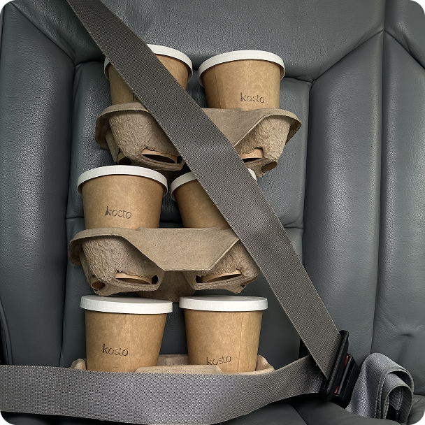 Coffee on board: six takeaway cups safely buckled up in the backseat.