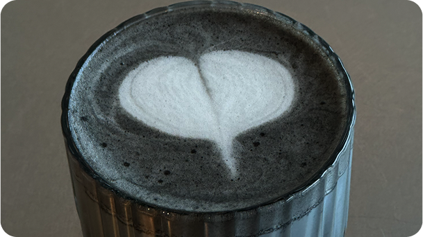 Black latte with heart artcoffee meets creativity.