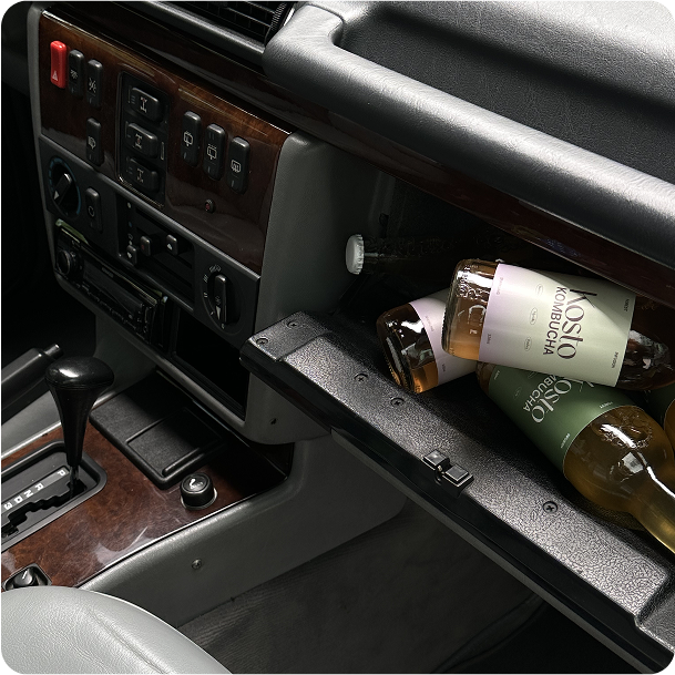 Glovebox surprise: Kosto drinks and bottles tucked into a vintage dashboard.